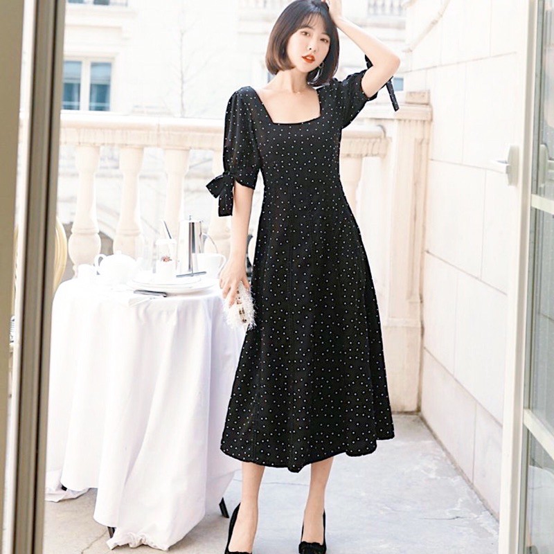 Đầm bi đen tay nơ