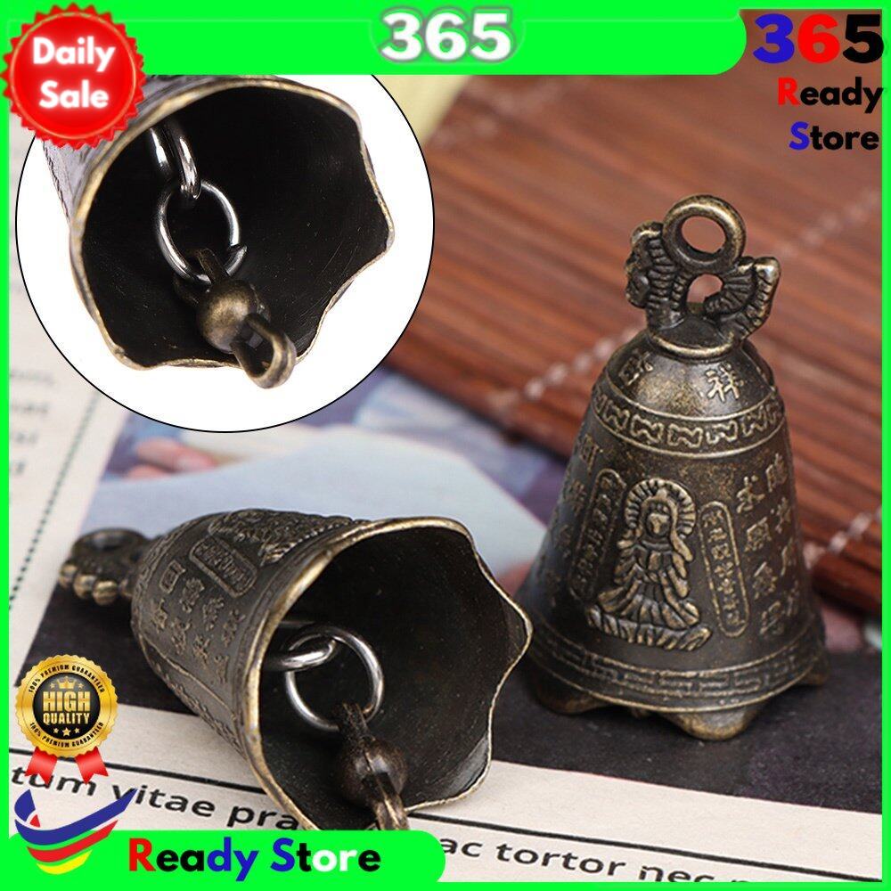 an antique Asian bell sculpture from Shui Feng that has a bell for the Guanyin Buddha