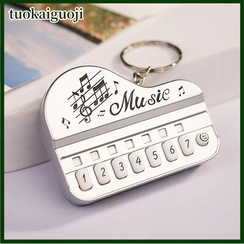 tuokaiguoji 1 cái xách tay mini sáng tạo âm nhạc điện tử đàn piano bàn phím Keychain vòng với ánh sáng lên phím Mặt dây chuyền trẻ em của đồ chơi game máy nghe nhạc