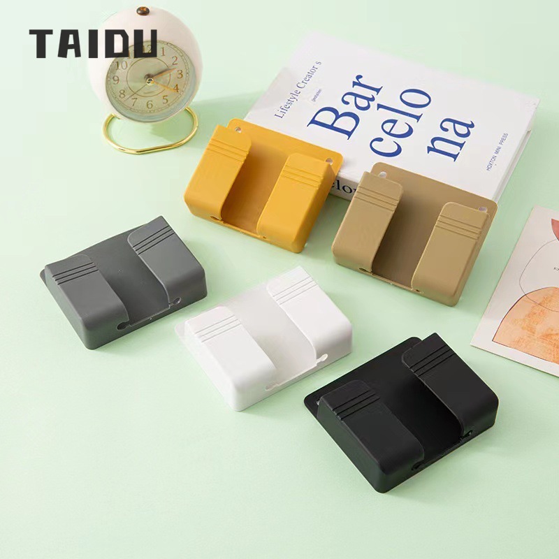 Punch-free mobile phone holder remote control storage box bedroom bedside mobile phone charging box multi-function wall-mounted storage rack ราคา 18 บาท*ส่งฟรี